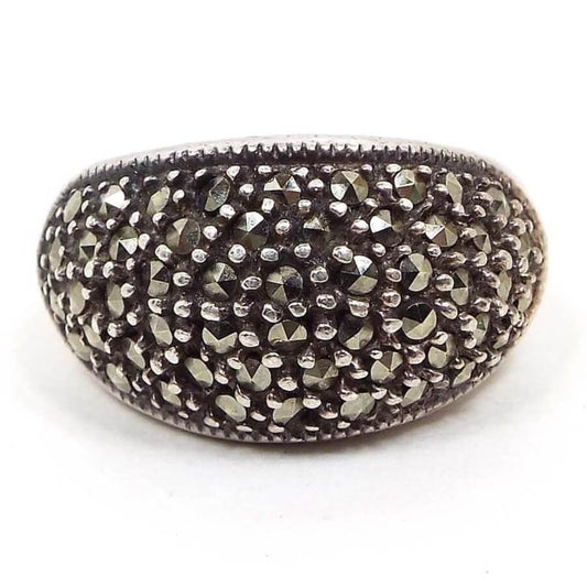 Front view of the retro vintage marcasite dome ring. The sterling silver has a slightly darkened patina from age. There are small round faceted marcasite stones all over the top of the ring with dots of sterling in between.