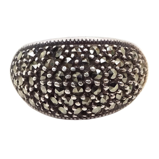 Front view of the retro vintage marcasite dome ring. The sterling silver has a slightly darkened patina from age. There are small round faceted marcasite stones all over the top of the ring with dots of sterling in between.