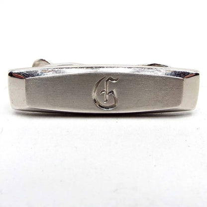 Front view of the Mid Century vintage Hickok initial tie clip. It is silver tone in color with the letter G engraved on the front.