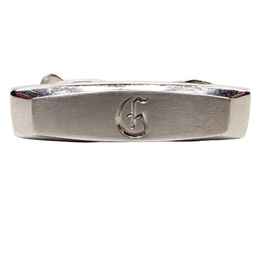 Front view of the Mid Century vintage Hickok initial tie clip. It is silver tone in color with the letter G engraved on the front.