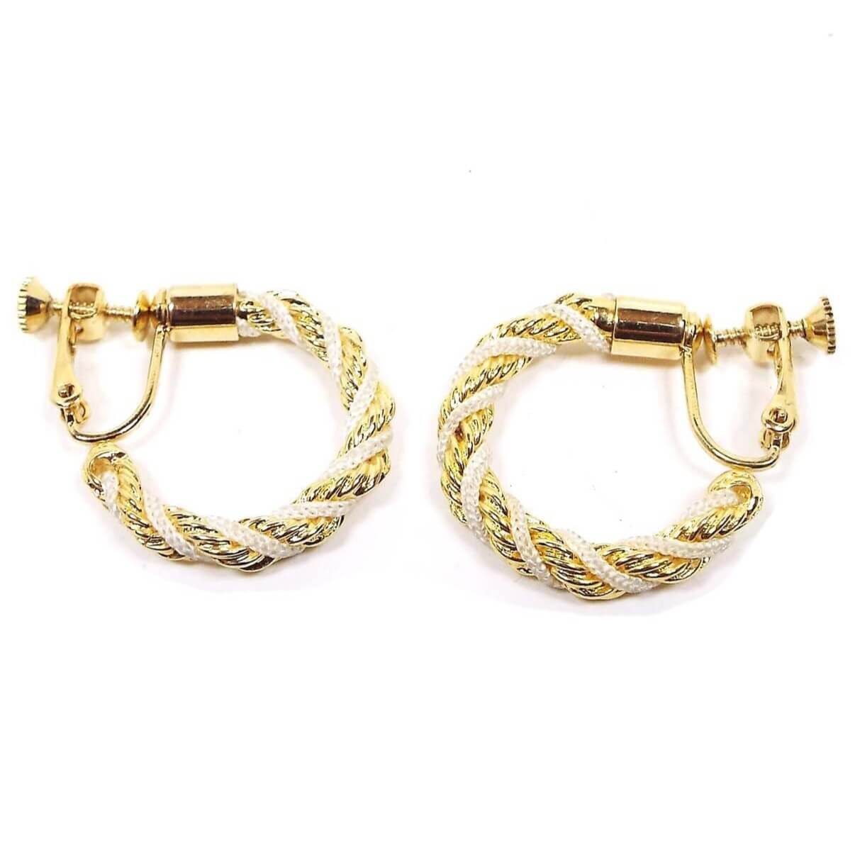 Side view of the Napier retro vintage hoop earrings. The metal is gold tone in color. The hoops are twisted with metal chain and white nylon cord. The clip on backs have screws so you can adjust them for comfort.
