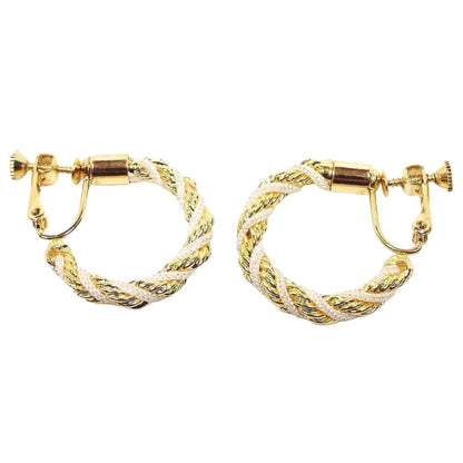Side view of the Napier retro vintage hoop earrings. The metal is gold tone in color. The hoops are twisted with metal chain and white nylon cord. The clip on backs have screws so you can adjust them for comfort.