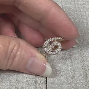 Video showing the sparkle of the rhinestones on the retro vintage Edco knot ring.