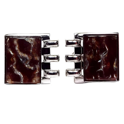 Front view of the Mid Century vintage lucite cufflinks. The metal is silver tone in color. The front cabs are rectangle and have shades of dark brown marbled in with lighter browns. One side of each cufflinks has three bars of metal coming off the side.