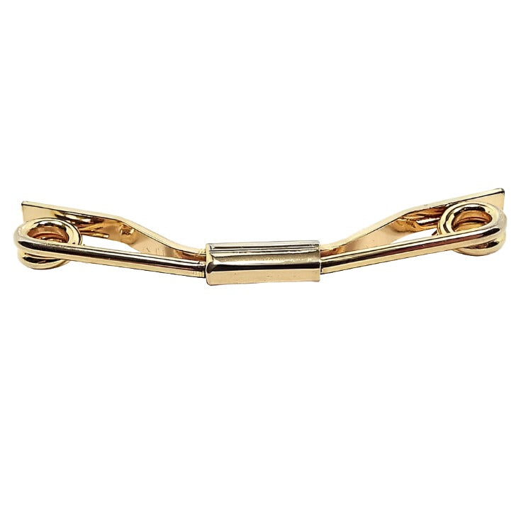 Angled front view of the 1950's Mid Century vintage collar clip. It is gold tone with spiral ends and an angled back.