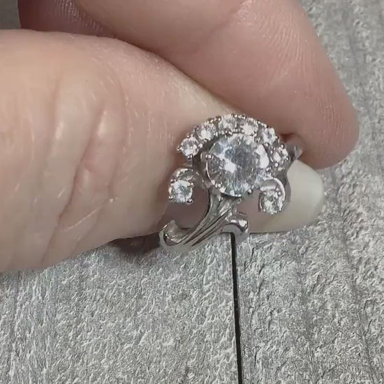 Video of the Mid Century vintage sterling silver flower ring with round clear quartz stones. The video is showing how the stones sparkle.