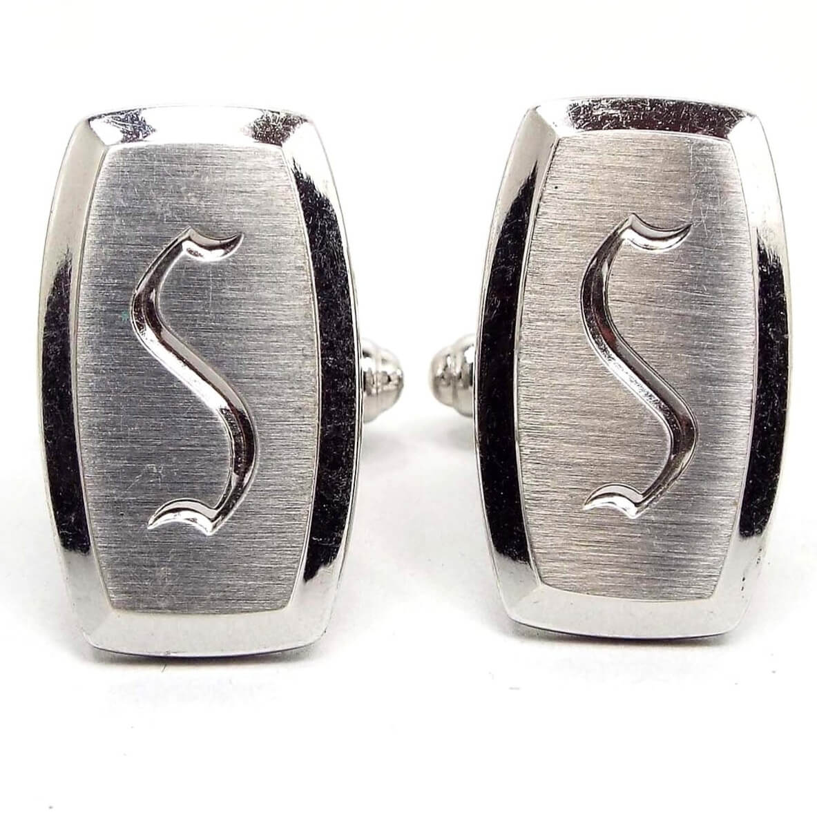 Front view of the Mid Century vintage Hickok initial cufflinks. They are silver tone in color and have a rounded edge rectangle shape. The front has matte brushed metal with the letter S engraved on in the middle.