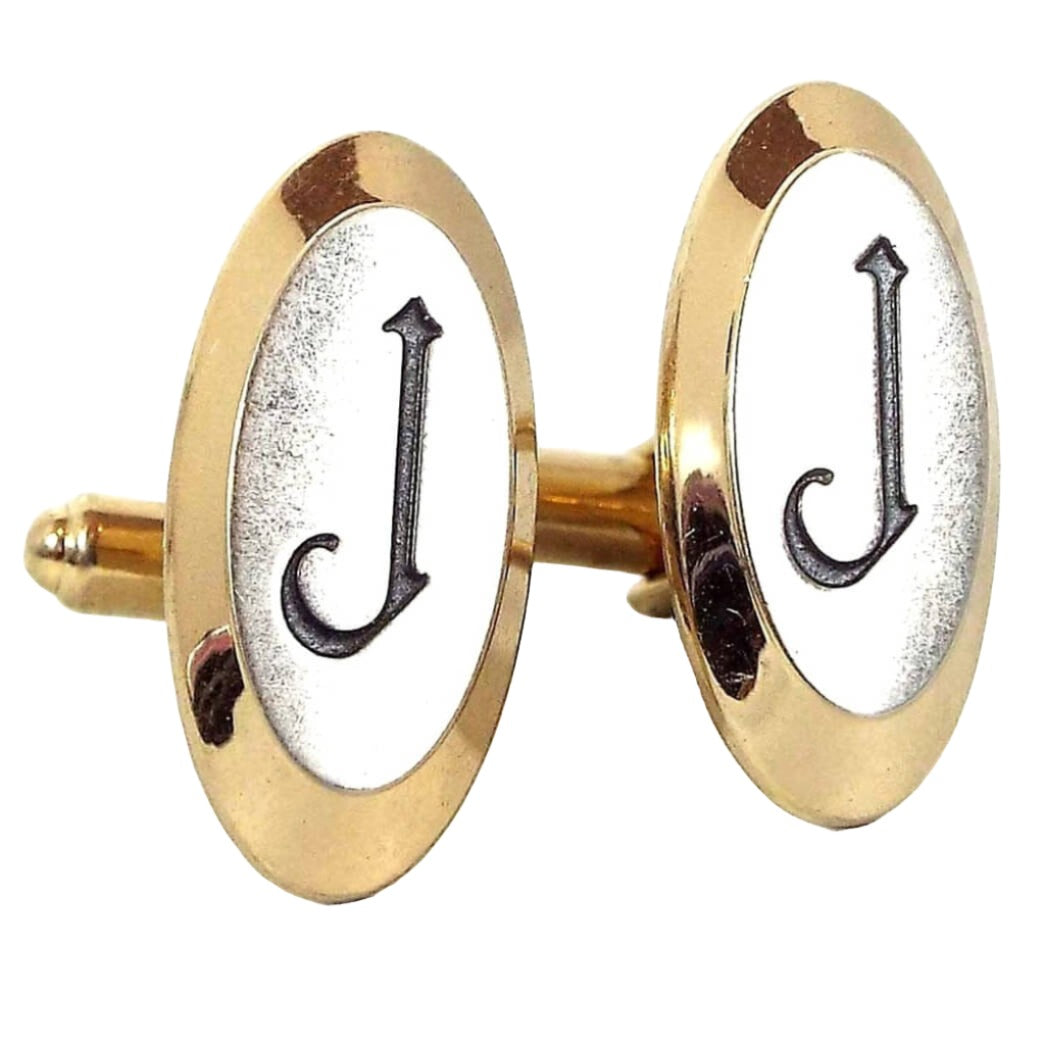 Front view of the Hickok Mid Century vintage initial cufflinks. They are oval in shape and mostly gold tone in color. The fronts have silver tone color metal with the letter J engraved on the front in black.