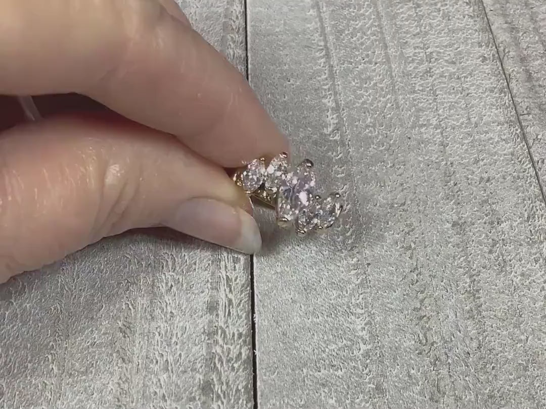 Video of the retro vintage Edco cubic zirconia cocktail ring. The metal is gold tone in color. There are marquis shaped CZ stones on the top in an offset pattern. The video is showing how the stones sparkle.