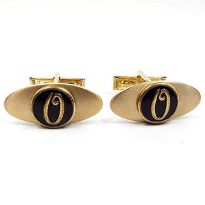 Front view of the retro vintage initial cufflinks. They are oval and gold tone in color. The front has a black painted circle area in the middle with a gold tone letter O on it. 