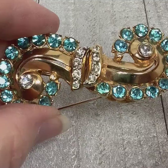 Video of the 1930's Coro duette brooch fur clip combo. The video shows how the rhinestones sparkle and how the brooch comes apart to form two fur clips if you choose to wear them that way.
