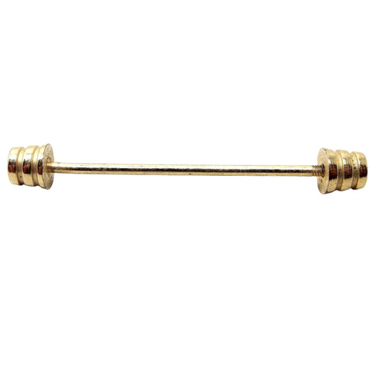 Side view of the Mid Century vintage collar bar. It is gold tone in color and has tapered cone ends with a cut striped design.