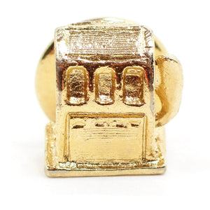 Enlarged front view of the Mid Century vintage novelty tie tack. It is gold tone in color and is shaped like an old gas pump. 