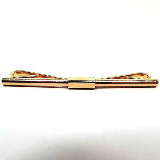 Front view of the retro vintage collar clip. It is gold tone in color and has a plain almost straight bar on the front.