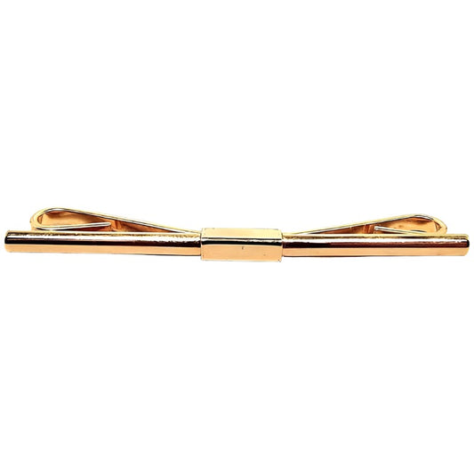 Front view of the retro vintage collar clip. It is gold tone in color and has a plain almost straight bar on the front.