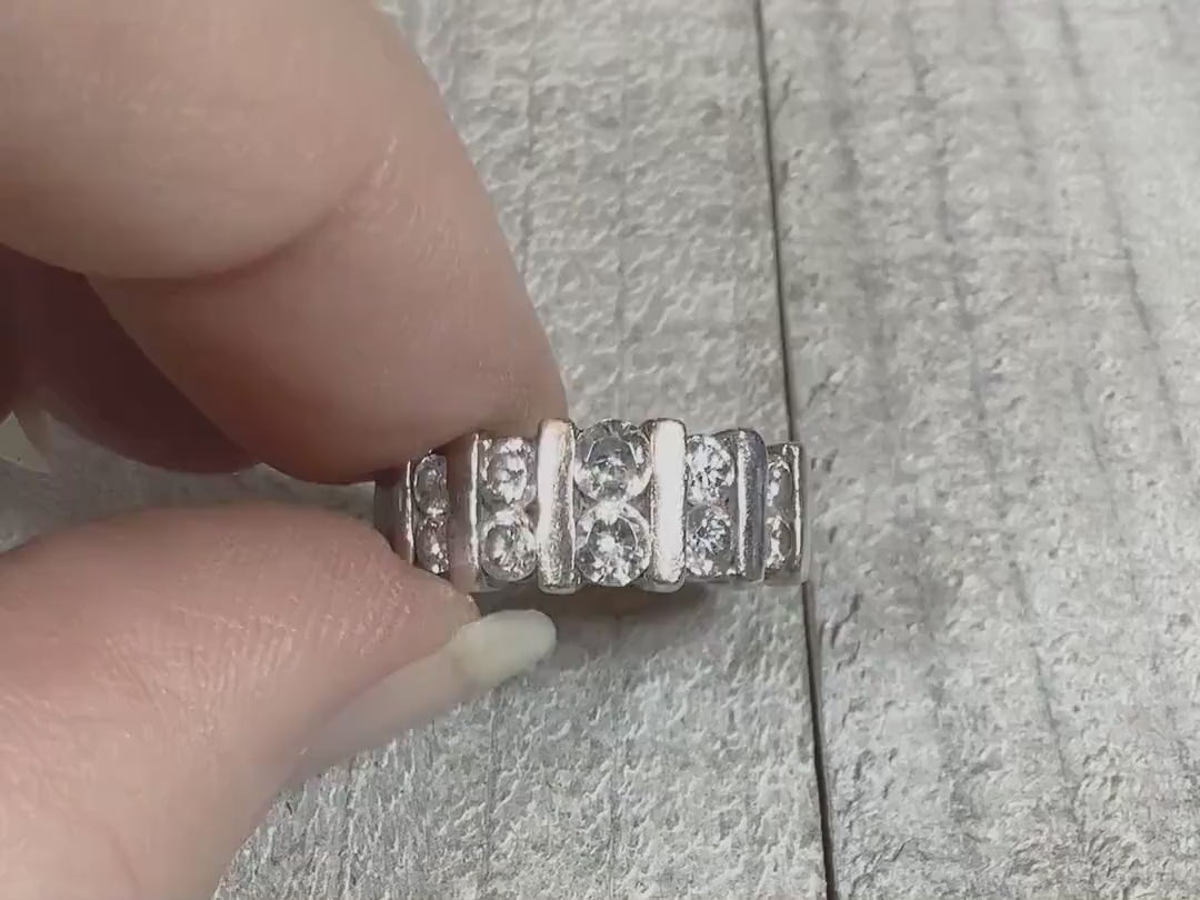 Video showing the sparkle on the retro vintage sterling silver cubic zirconia band ring. There are two rows of round cz stones on the top of the ring separated by vertical sterling bars.