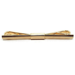 Front view of the Mid Century vintage collar clip. It is gold tone in color and has an almost straight bar on the front with just a slight curve to it for wear.