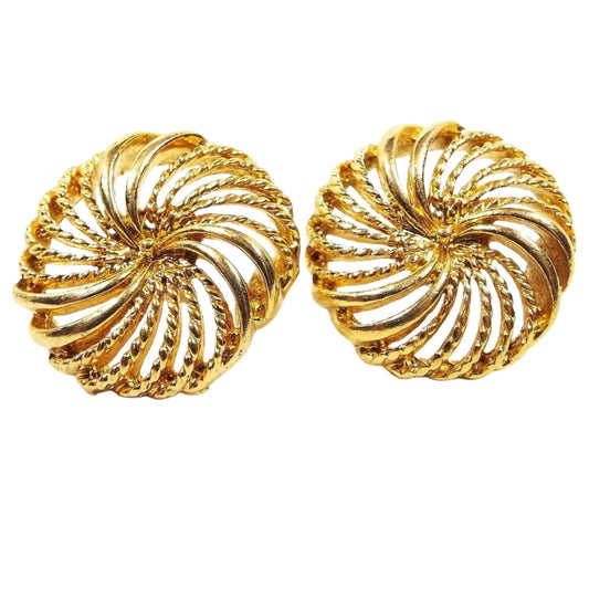 Front view of the retro vintage Napier post earrings. The are rounded filigree pinwheel shape with gold tone color metal.