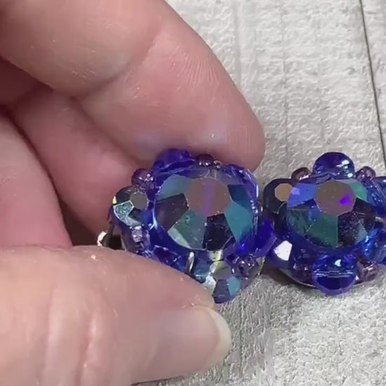 Video of the Mid Century vintage cluster beaded clip on earrings. The glass crystal beads are blue in color and the video is showing how they sparkle as you move around.
