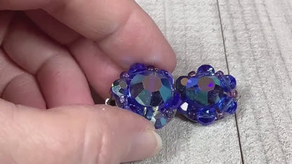 Video of the Mid Century vintage cluster beaded clip on earrings. The glass crystal beads are blue in color and the video is showing how they sparkle as you move around.