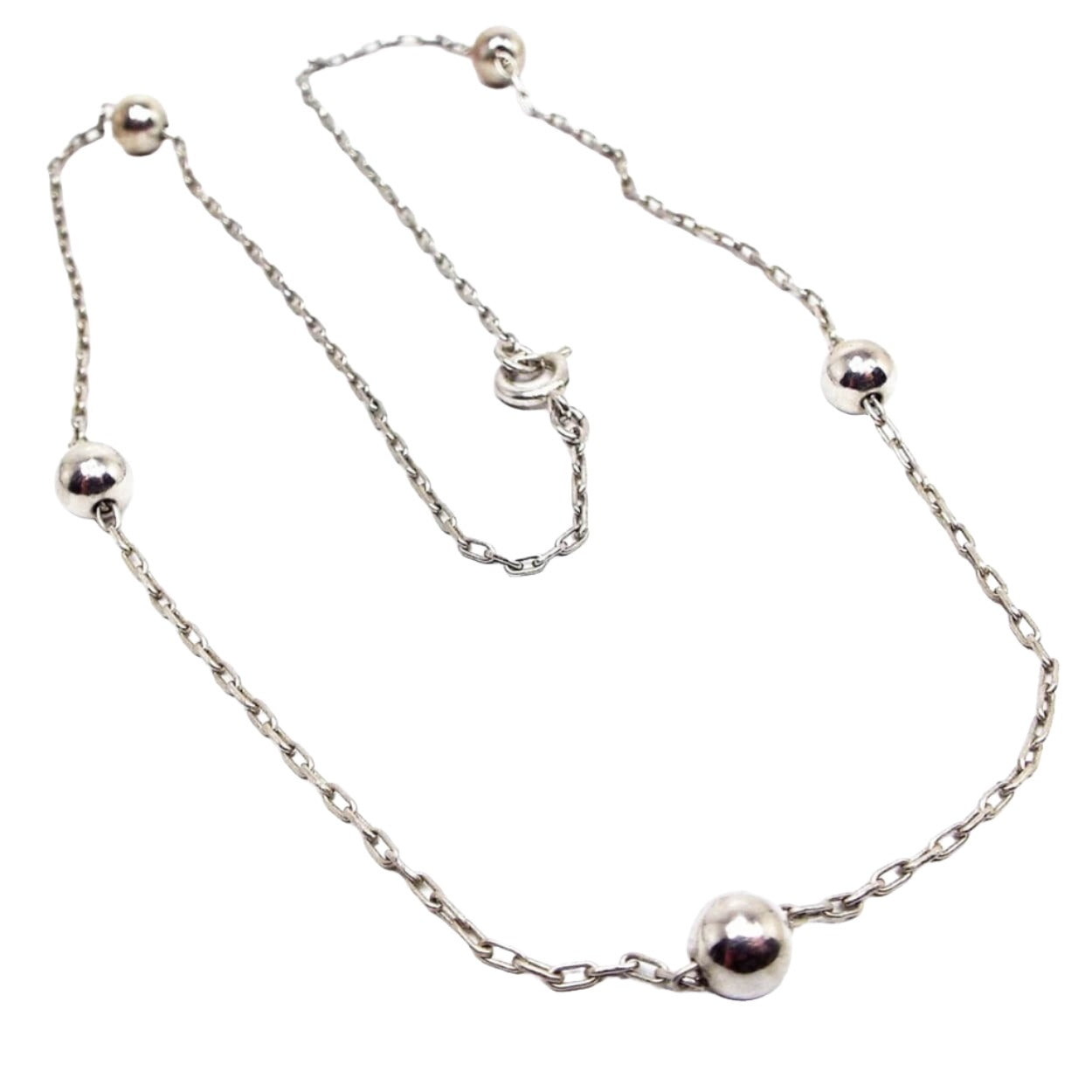 Retro vintage metal beaded chain necklace. There is a thin cable chain in silver tone color with small round metal beads here and there. Necklace has a spring ring clasp.