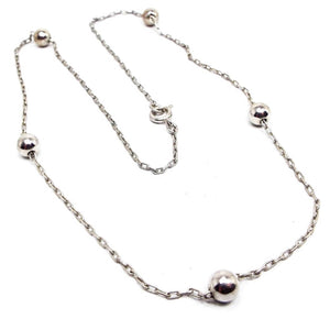 Retro vintage metal beaded chain necklace. There is a thin cable chain in silver tone color with small round metal beads here and there. Necklace has a spring ring clasp.