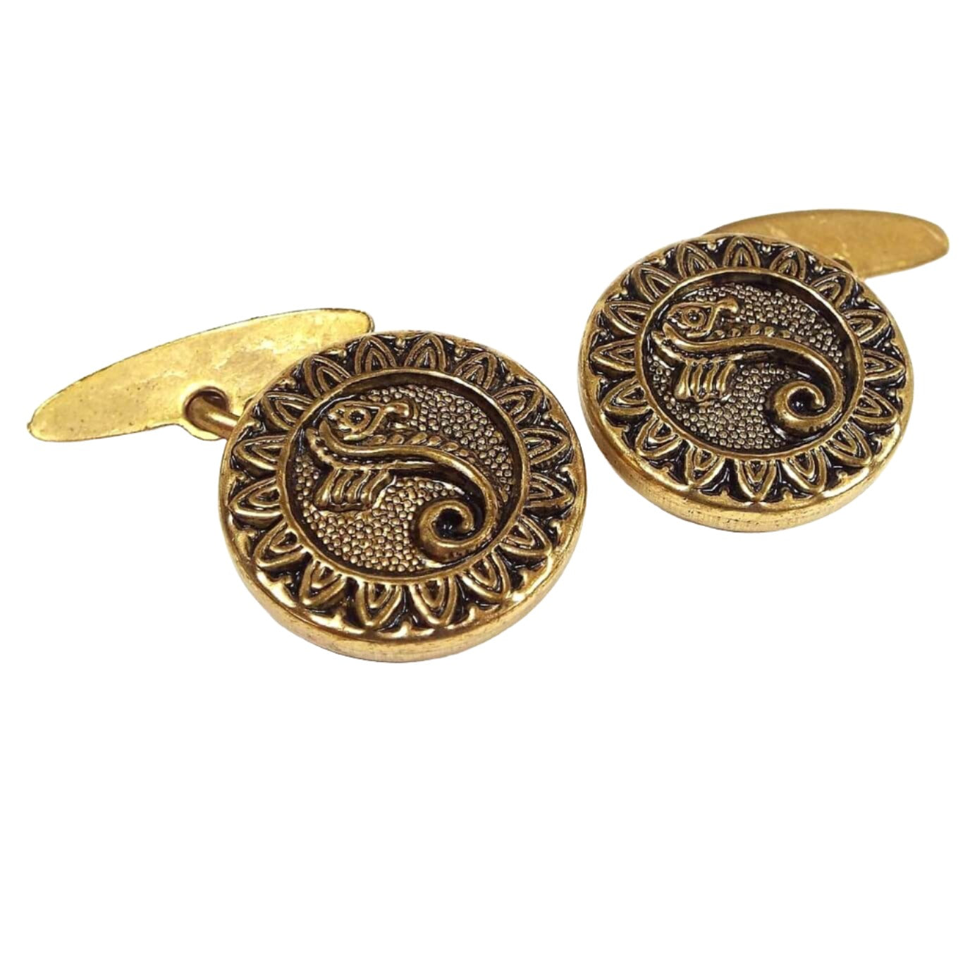 Front view of the Mid Century vintage button cufflinks. The metal is antiqued brass color. The fronts are round with a textured and raised seahorse and sunflower design. The backs are oval held with a link between the front and back.