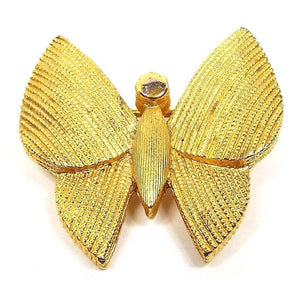 Front view of the retro vintage Crown Trifari brooch pin. The metal is gold tone in color. It's shaped like a butterfly with textured body and wings.