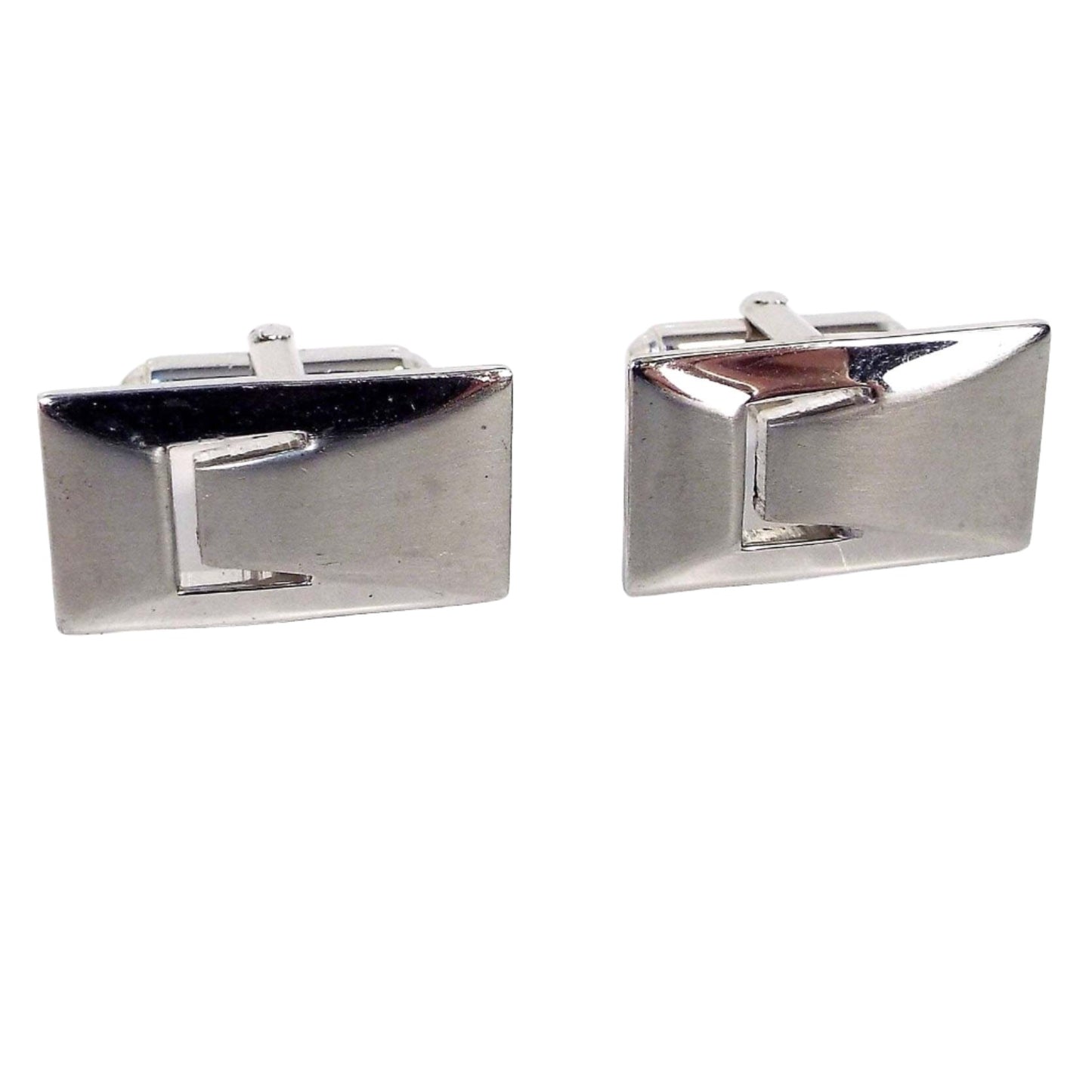 Front view of the Mid Century vintage Anson Modernist style cufflinks. They are silver tone in color and rectangular in shape. There is a cut out similar to the letter C on the left side.