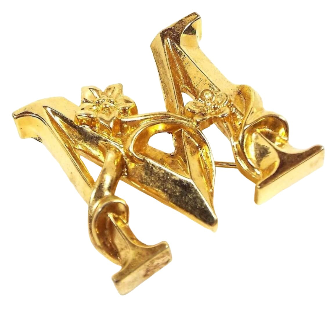 Front view of the retro vintage Avon initial brooch pin. It is gold tone in color and is shaped like a block letter M. There are two flowers wrapped around the front of the M.