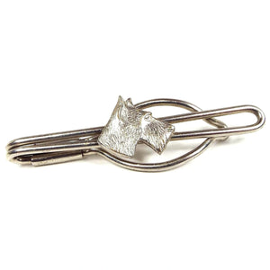 Front view of the 1940's Mid Century vintage dog tie bar. It has an open wire style design with silver tone color metal. In the middle is a head shaped like a Scotty dog.
