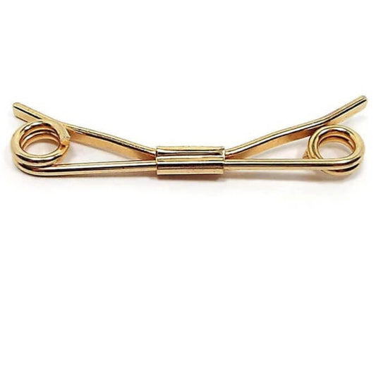 Side view of the Large Coil End Vintage Collar Clip. The metal is gold tone in color and has spirals on the end. 