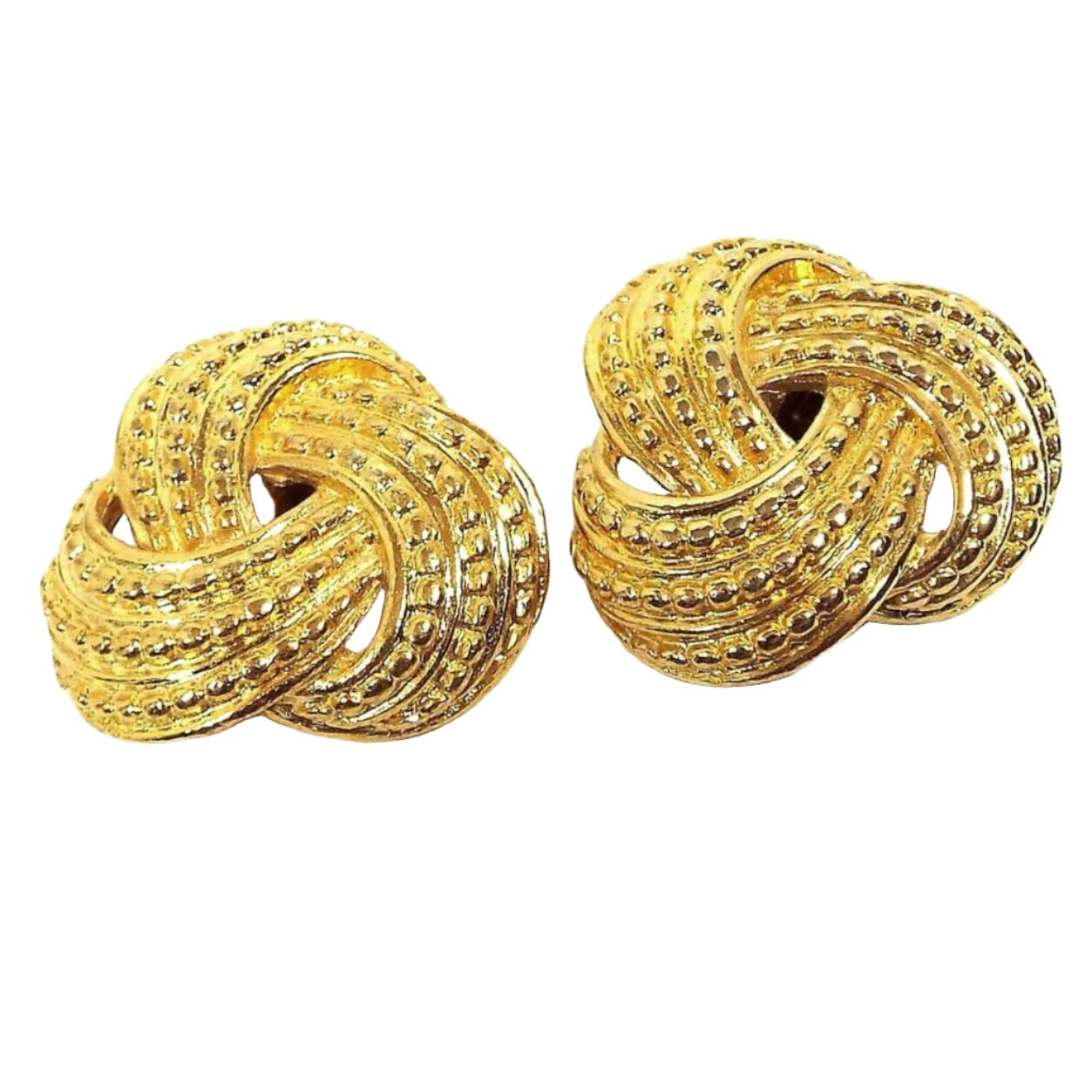 Front view of the retro vintage shoe clips. The metal is gold tone plated in color. They are shaped like twisted knots and have a bumpy textured pattern on them.