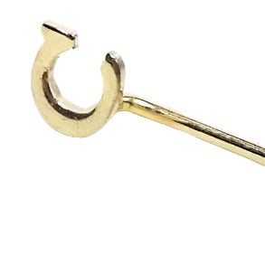 Enlarged view of the top of the Mid Century vintage initial stick pin. The metal is gold tone in color. There is a small flat block letter C at the top.