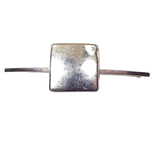 Front view of the Mid Century vintage square collar clip. The metal is silver tone in color. There is a squared bar on either side of a large square in the middle. 