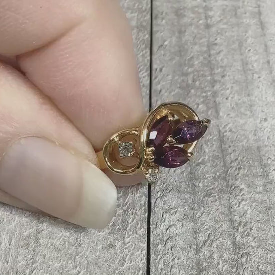 Video of the retro vintage rhinestone cocktail ring. The metal is gold tone in color. There are three marquis shaped purple rhinestones on the top and small round clear rhinestones here and there around them. The video is showing how the rhinestones sparkle.