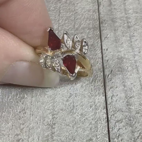 Video of the retro vintage Vargas rhinestone ring. There are two teardrop red rhinestones at the top with smaller round clear rhinestones on either side. The video shows how they sparkle. 