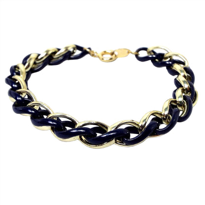 Front view of the retro vintage Trifari twisted chain bracelet. Some of the links are gold tone in color and the middle ones are enameled in a very dark blue color. 