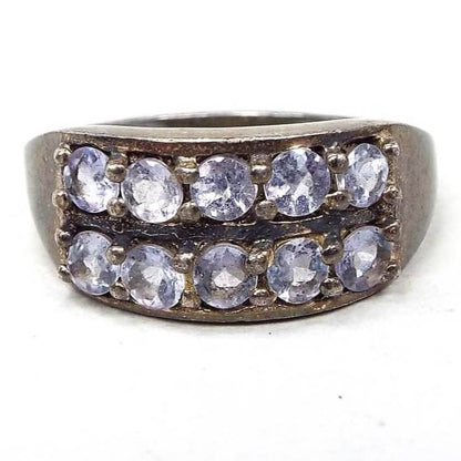 Front view of the retro vintage sterling silver cubic zirconia ring. The silver is darkened in color from age. There are two rows of stones on the top. They are small prong set round and have a very light blue to purple color depending on the light.