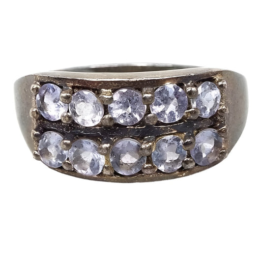 Front view of the retro vintage sterling silver cubic zirconia ring. The silver is darkened in color from age. There are two rows of stones on the top. They are small prong set round and have a very light blue to purple color depending on the light.