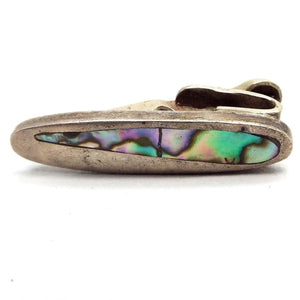 Tie Clip is sterling silver and darker silver in color. Front has an oval shape with an abalone shell cab that is a tapered oval with one end larger going down to a smaller end on the other side. Abalone has swirls of pearly color that shimmer as you move in green, blue, and purple. Front part of the whole piece is flat. 