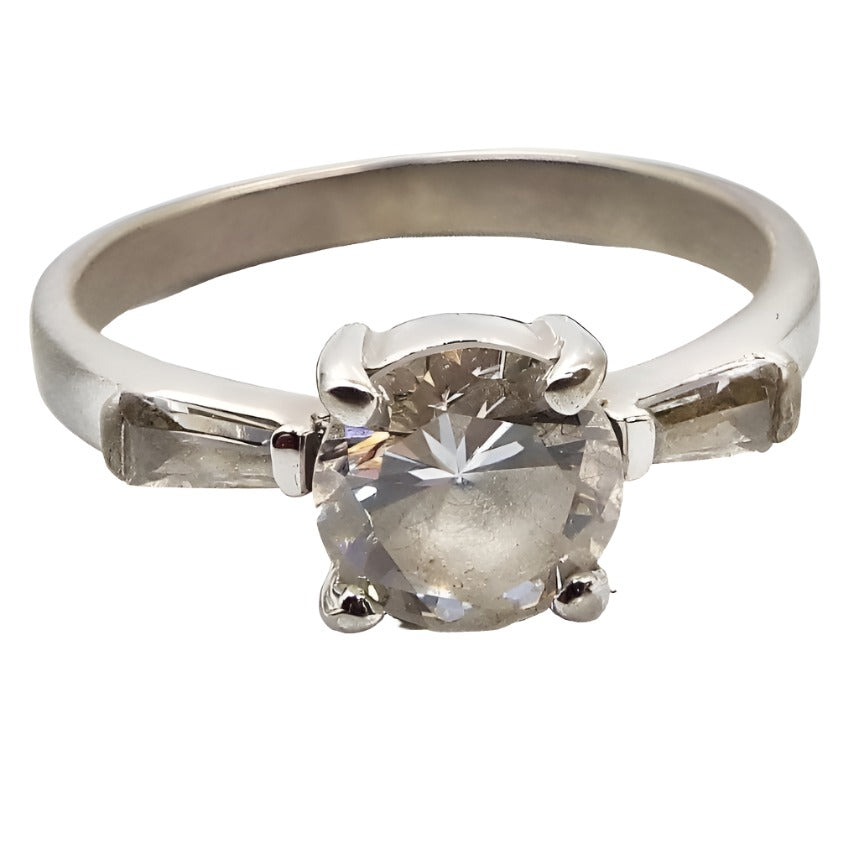 Front view of the retro vintage sterling silver cubic zirconia ring. The sterling is a very slightly darkened silver color. There is  a round prong set CZ stone in the middle with a trapezoid channel set CZ stone on either side.