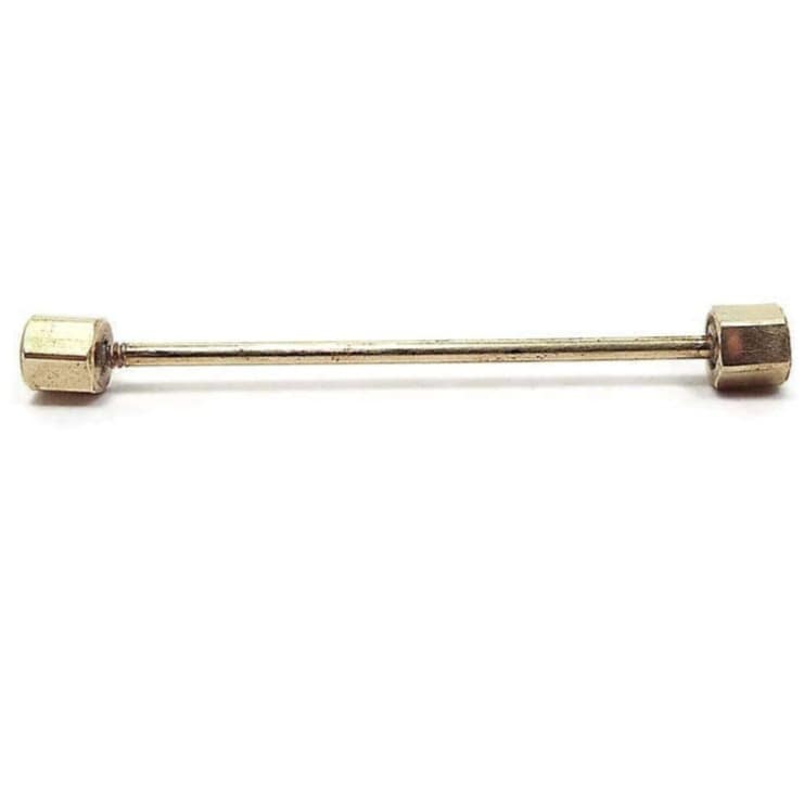 Side view of the Mid Century vintage collar bar. The metal is gold tone in color. Each end has a faceted octagon shaped end. There is a thin round metal bar that goes from end to end.