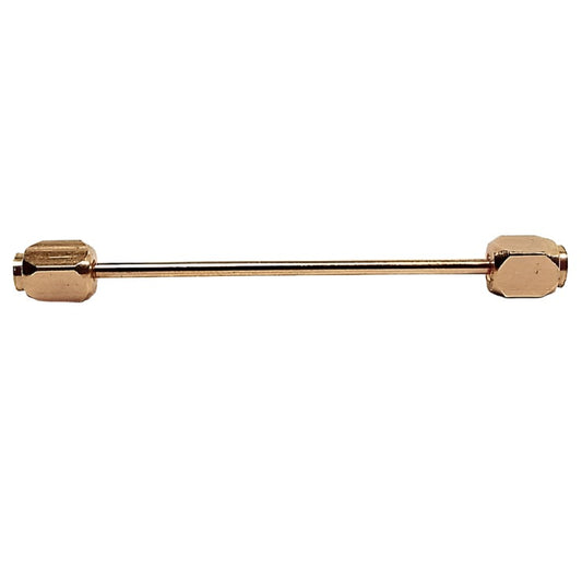 Side view of the Japanese Mid Century vintage collar bar. the metal is a darker gold tone in color. There is a thin round plain bar in the middle. The ends have hexagon shapes with flat circle shapes on the very end.