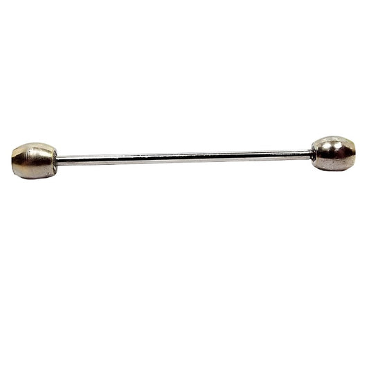 Side view of the Mid Century vintage two tone collar bar with oval ends. The ends are light gold tone in color. The bar is silver tone in color.