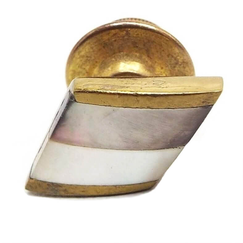 Tie tack is brass in color. It is an angled square with one stripe of abalone shell that is pearly gray in color with hints of other colors and another stripe that is mother of pearl that is a pearly white in color.