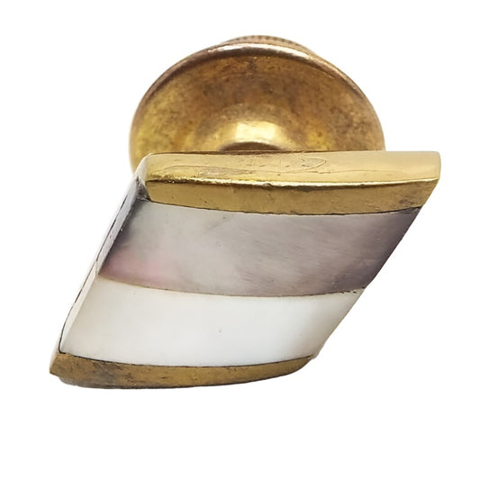 Tie tack is brass in color. It is an angled square with one stripe of abalone shell that is pearly gray in color with hints of other colors and another stripe that is mother of pearl that is a pearly white in color.