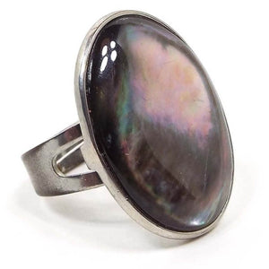 Front view of the retro vintage adjustable abalone Boho statement ring. The metal is silver tone in color. There is a large oval abalone shell cab on top that is bezel set. The band is flat curved and has a split style at the top. 