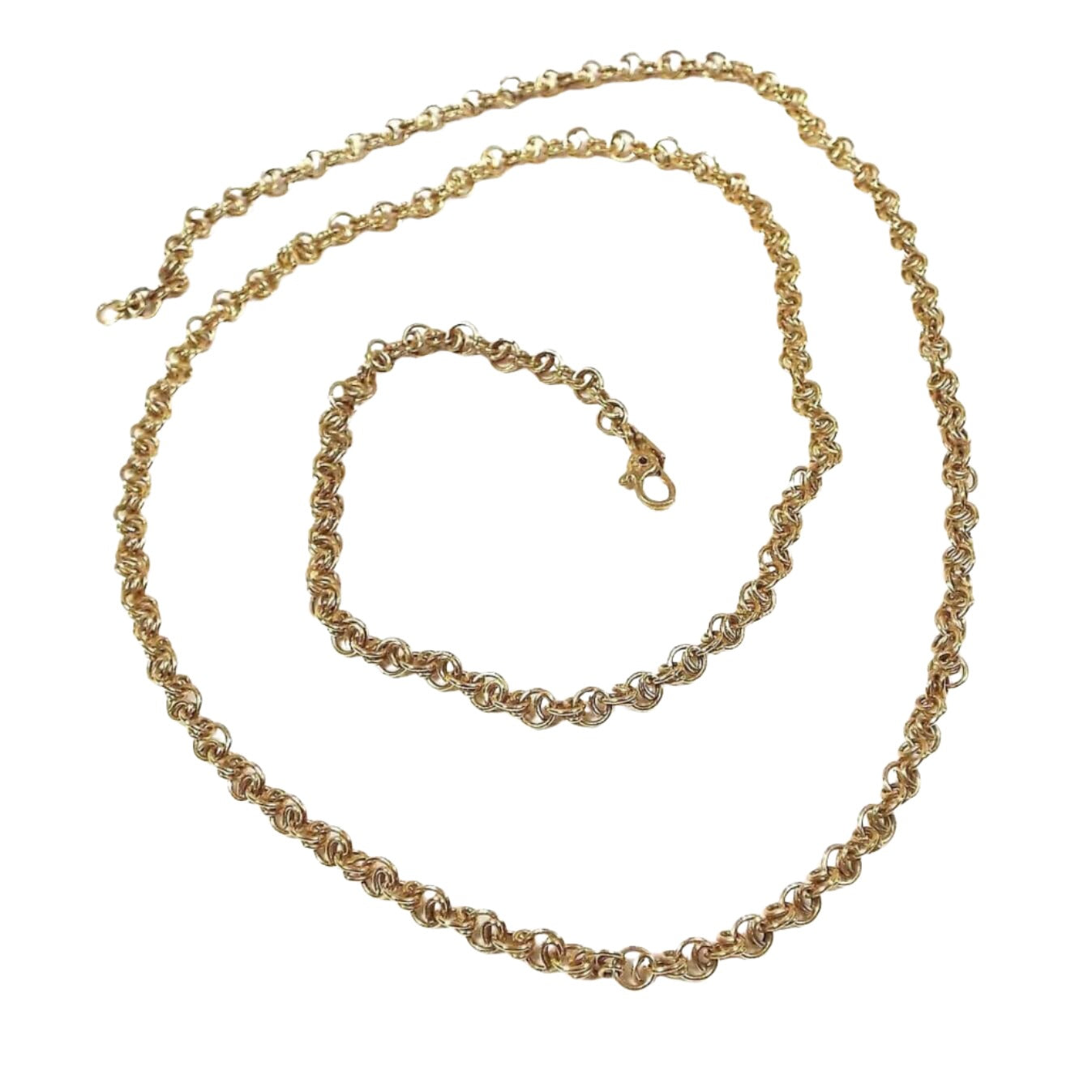 Top view of the retro vintage Monet chain necklace. The metal is gold tone in color. The links on the chain are a fancy round double curved link for a coiled appearance. They are linked together cable chain style. There is a hinged clip clasp and a rectangle hang tag with Monet on it at the end.