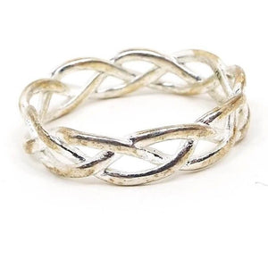 Angled front and side view of the retro vintage IBB TH sterling silver band ring. The ring has an open braided Celtic style design. The silver is slightly darkened from age. 